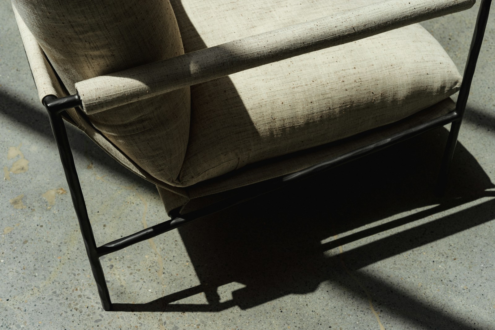 Illustrative reference photograph of an upholstered accent armchair with a metal frame; not NicLogistics inventory.