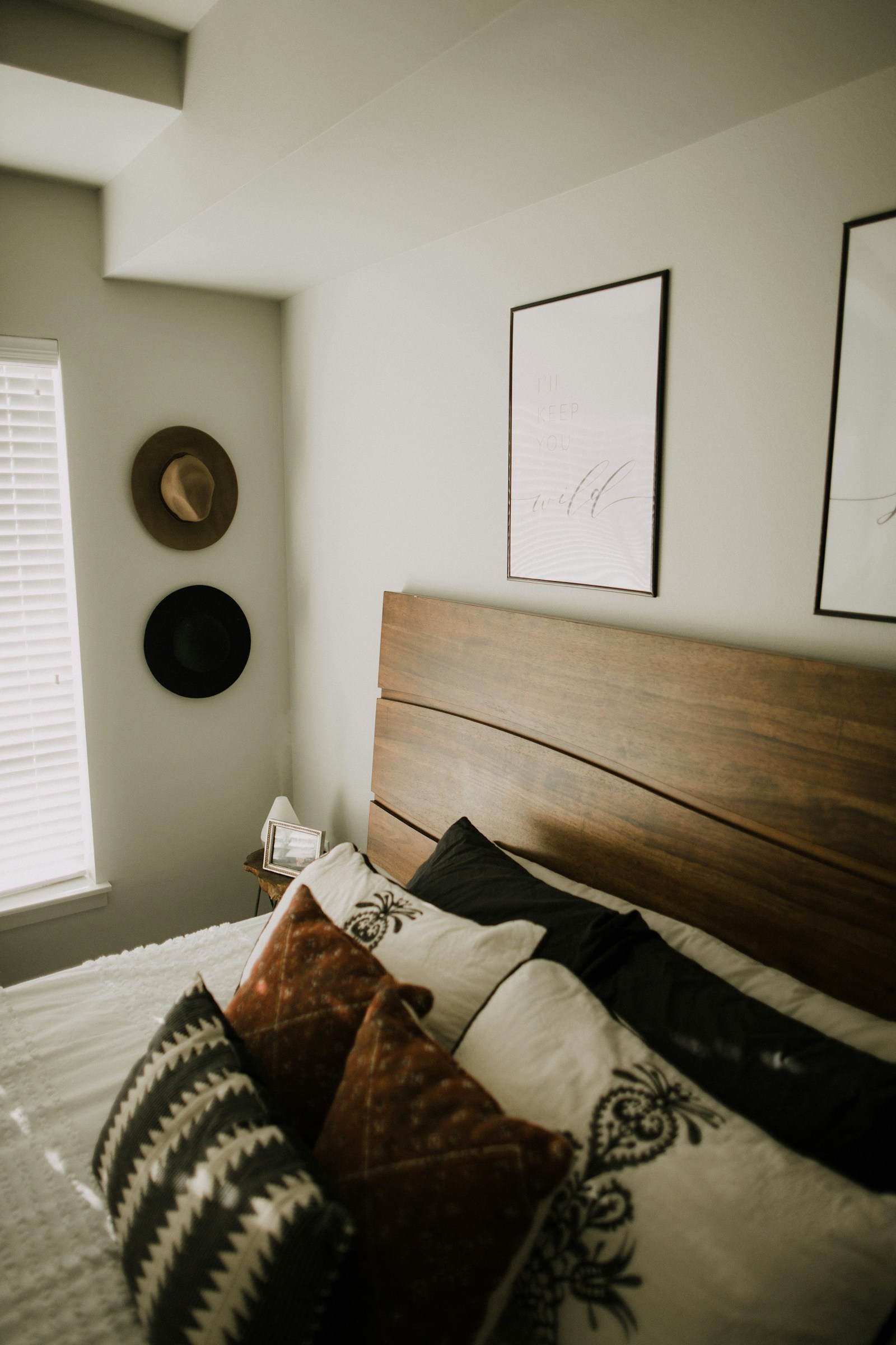 Illustrative reference photograph of a dark wooden bed frame in a bedroom; not NicLogistics inventory.